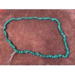 A rough cut malachite necklace, length 80cm.