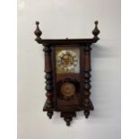 A hanging wall clock with brass face and glass panels to side, height 79cm, width 40cm, with