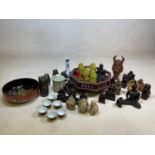 A quantity of Oriental items including Buddhas, ceramic saki set, three wise monkeys and other