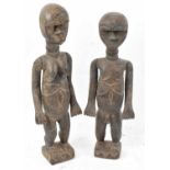 A pair of Lobi, Bukina Faso figures each with articulated arms, height 60cm and 57cm.Provenance: