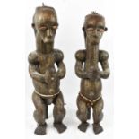 A pair of Fang, Gabon, reliquary figures set with bone eyes and clad throughout with brass and