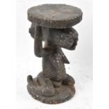 A Luba, Democratic Republic of Congo, stud decorated figural stool, height 65cm.Provenance: This