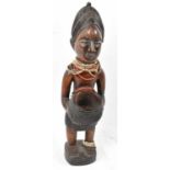 A Baule, Ivory Coast, figure with bead adornments, height 56cm.Provenance: This collection has
