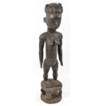 A Tiv, Nigeria, large figure with incised detail mounted on a integral stool base, height 78cm.