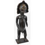 A Fang, Gabon figure with carved coiffeur and applied with brass detail on contemporary display