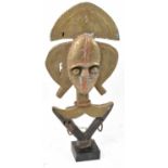 A Kota reliquary figure, Gabon, brass mounted with three iron rings and on a contemporary mount,