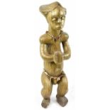 A Fang reliquary figure, Gabon, entirely clad in brass and with bead jewellery, height 71cm.