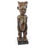 A Chokwe, Angola, brass detailed figure raised on contemporary display plinth, height 71cm.