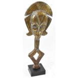 A Kota reliquary figure, Gabon, brass applied and on contemporary mount, height 66.5cm.Provenance: