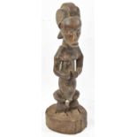 A Fang, Gabon, figure set in a rustic wooden stand, height 52.5cm.Provenance: This collection has