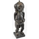 A Fang, Gabon figure with carved coiffeur and brass stud detail mounted on a contemporary display
