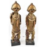 A large pair of Ambété fetish figures, Gabon, brass clad and adorned with cowry shells for eyes,