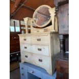 An early 20th century pine mirror back dressing table with an arrangement of five drawers, on