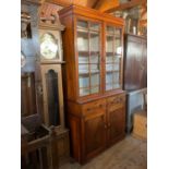 A 19th century mahogany sideboard with associated bookcase top, the upper section with a pair of