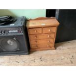 A miniature pine chest of two short over three long drawers, on plinth base, width 36cm, depth 16cm,