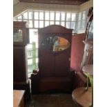 An Edwardian inlaid mahogany hall stand with oval bevelled mirror above hinged seat, height 200cm.