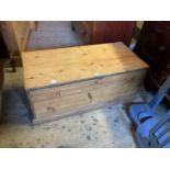 An old pine blanket chest with iron handles, on plinth base, width 108cm.