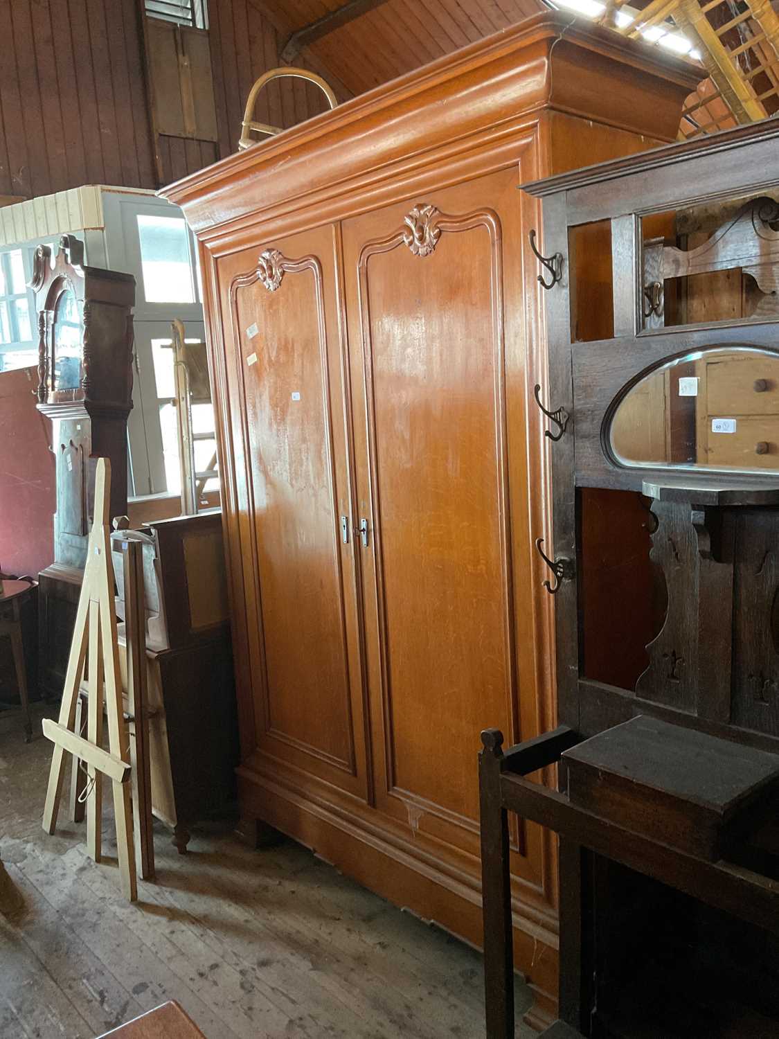 An oak armoire with moulded cornice and carved doors, on bracket legs, height 223cm, width 160cm,