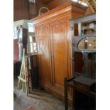 An oak armoire with moulded cornice and carved doors, on bracket legs, height 223cm, width 160cm,