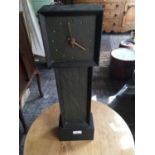 A slate mantel clock in the form of a longcase clock, height 56cm.