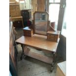 A 19th century Gothic Revival pitch pine mirror back dressing table, with an arrangement of four