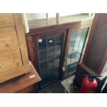 An oak bookcase with two leaded glazed doors, a painted side table with two drawers, width 90cm, and
