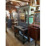 A 19th century carved oak hall stand with central bevelled mirror plate surrounded by carved panels,