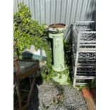 A green painted cast iron column.