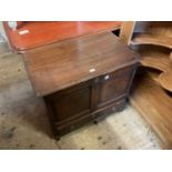 An 18th century and later oak chest with hinged top and panelled front above single base drawer,