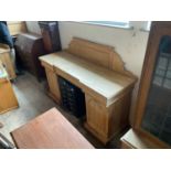 A Victorian pine inverted breakfront twin pedestal sideboard with raised back above three secret