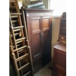 An 18th century oak tack cupboard with moulded cornice above two panelled doors, height 177cm, width