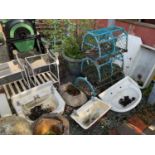 A painted chimney pot, with two white painted glass top tables, three bathroom sinks, three