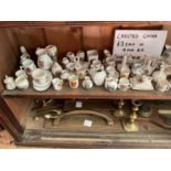 A large collection of assorted crested china and Wade Whimsies.