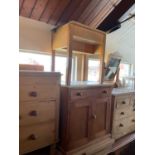 A vintage pine washstand with white painted top above a single drawer and two panelled cupboard