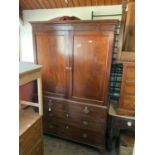 A 19th century mahogany press cupboard with moulded cornice above two panelled doors enclosing