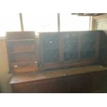 A modern oak dwarf bookcase with leaded glazed doors on shaped base, width 132cm, height 74cm,