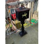 A cast iron postbox with crown finial, height 104cm.