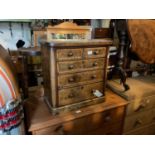 A Victorian walnut specimen chest of two short over three long drawers, with satinwood crossbanding,