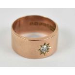 A 9ct rose gold ring set with central diamond, size N, approx 6.4g.