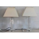 A pair of modern glass table lamps with white cream shades, height 46cm.