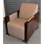 A contemporary leather upholstered reading chair with single flap to the right hand side.