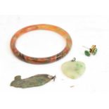 A mixed lot of Chinese hardstone jewellery comprising bangle, fish pendant, heart pendant, and