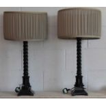A pair of ebonised barleytwist column table lamps, height to top of fitting 64cm.