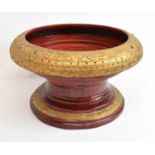 A large red painted gilt decorated and jewelled pedestal bowl, diameter approx 40cm.