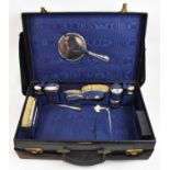 MAPPIN & WEBB; a good black leather cased travelling vanity set with hallmarked silver mounts for