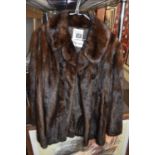 CALVIN KLEIN; a fur coat, size 14.