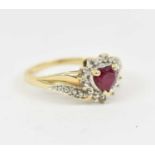 A 9ct yellow gold dress ring set with heart shaped central red stone, size O/P, approx 2.5g.