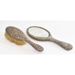 HENRY MATTHEWS; a Victorian hallmarked silver backed hand mirror and brush, Birmingham 1897/8.