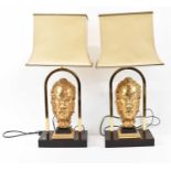 A pair of contemporary gilt metal stylised mask table lamps, height to fitment 54.5cm.