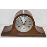 A 1920s oak cased eight day chiming mantel clock, width 42cm.